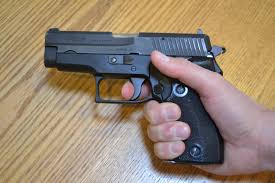 Pressing a trigger on a pistol